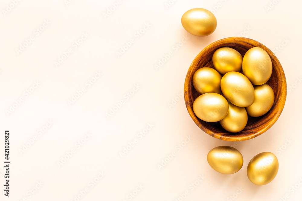 Golden eggs in wooden bowl. Wealth and good luck concept. Easter decoration Golden eggs in wooden bowl. Wealth and good luck concept. Easter decoration