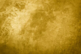 textured golden stucco background with scratches, scuffs and stains. plaster backdrop of yellow color for copy space