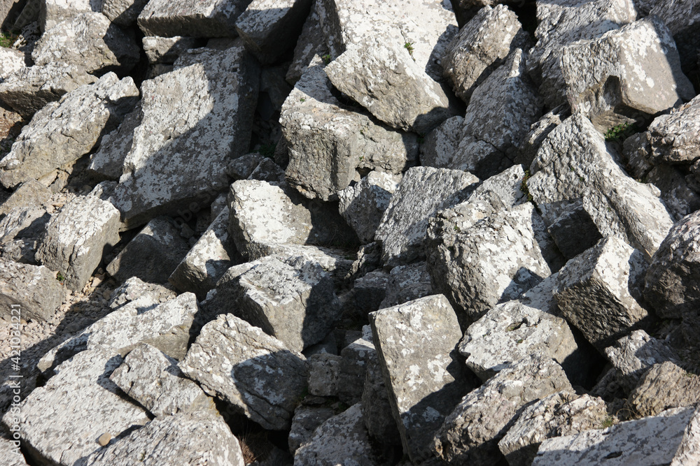 Pile of gray granite stones background.