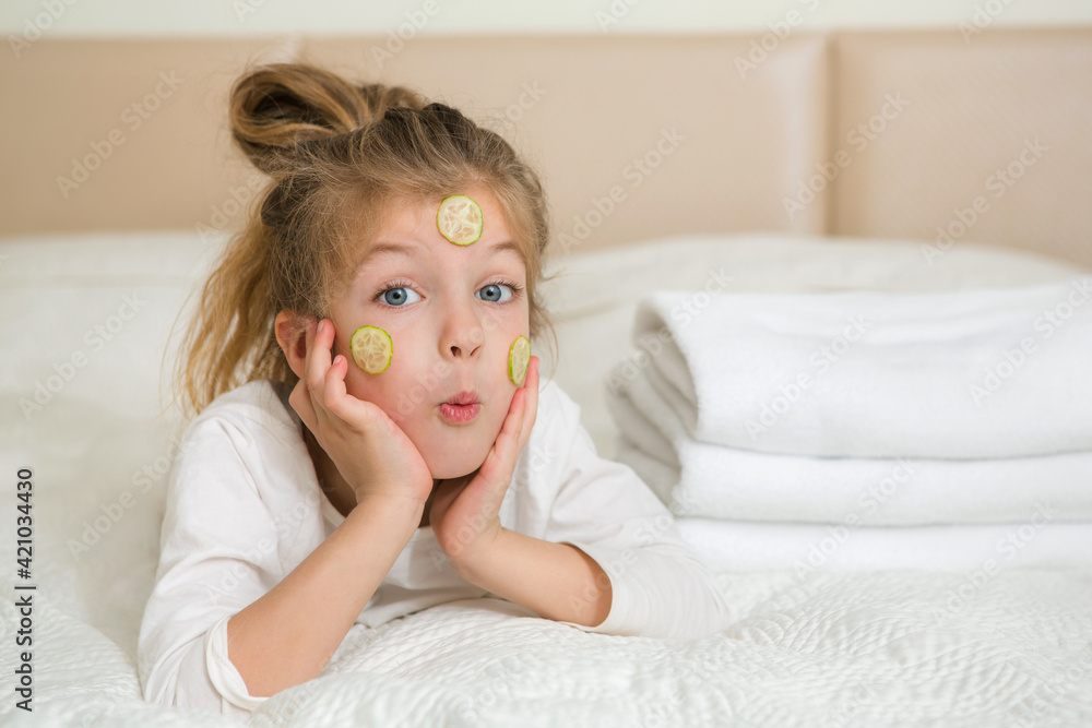 Portrait of a happy smiling child girl. Cute 5 years girl relaxing on the bed. Skin care concept. Portrait of a happy smiling child girl. Cute 5 years girl relaxing on the bed. Skin care concept.