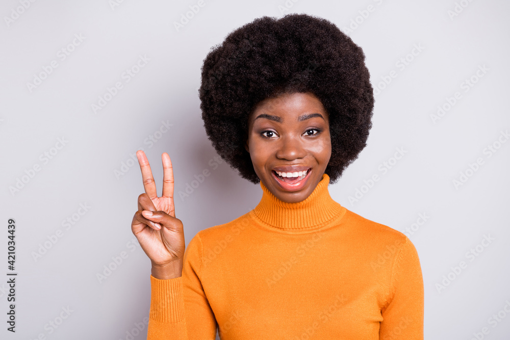 Photo of carefree attractive wavy hairdo dark skin person show fingers v-sign isolated on grey color background Photo of carefree attractive wavy hairdo dark skin person show fingers v-sign isolated on grey color background