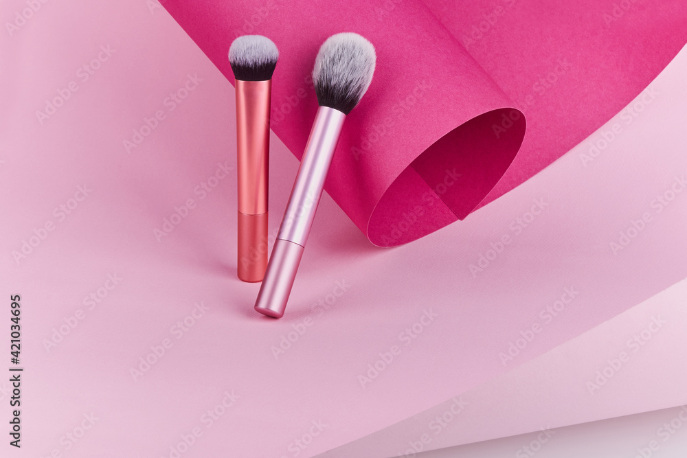 Makeup brushes on pink paper background. Cosmetic professional Make up Brushes Makeup brushes on pink paper background. Cosmetic professional Make up Brushes