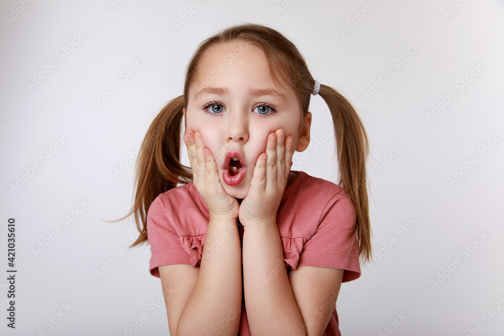 Girl with surprise suffering from toothache holding her cheek Girl with surprise suffering from toothache holding her cheek
