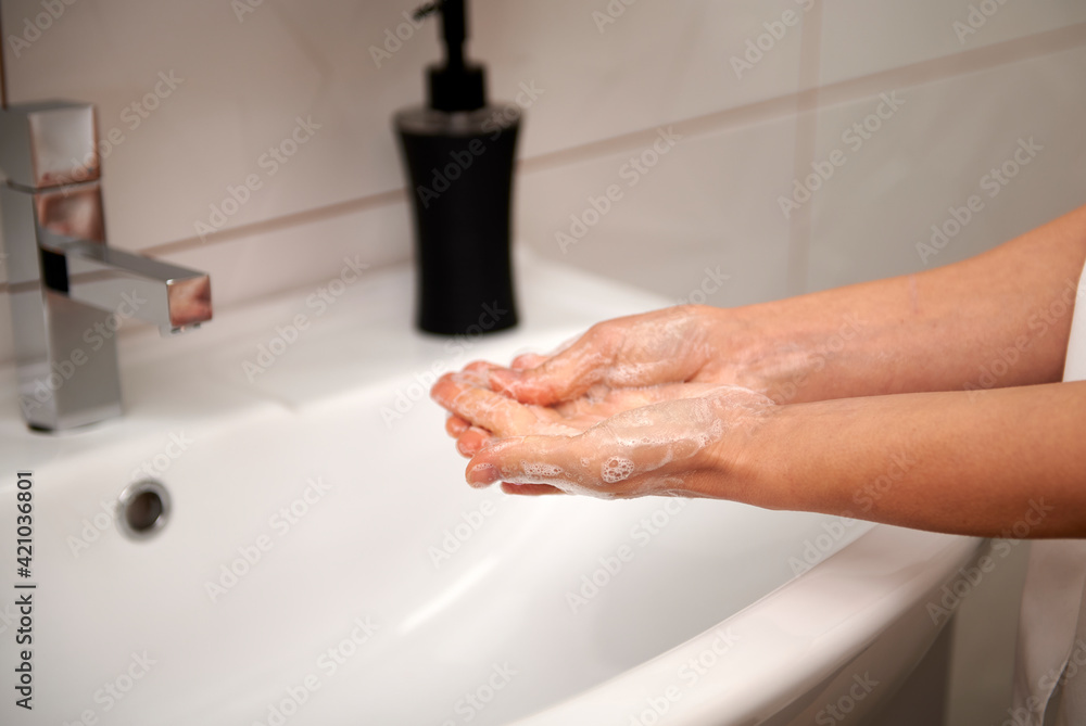 Woman washing hands to prevent virus COVID-19. Antiseptic, washing hands with soap or gel, antibacterial procedure for virus prevention Woman washing hands to prevent virus COVID-19. Antiseptic, washing hands with soap or gel, antibacterial procedure for virus prevention