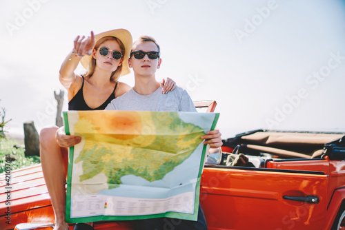 Young couple with map looking away © BullRun