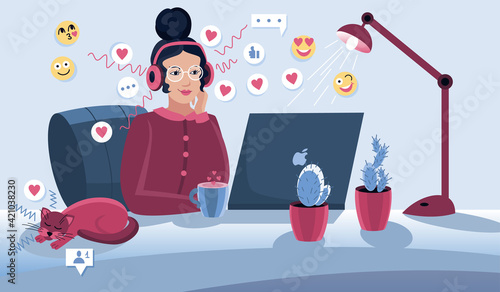 Social media manager or influencer at work. Cute girl sitting in comfy armchair and surfing internet on her laptop. Smiling young woman using social network at home. Online search and communication