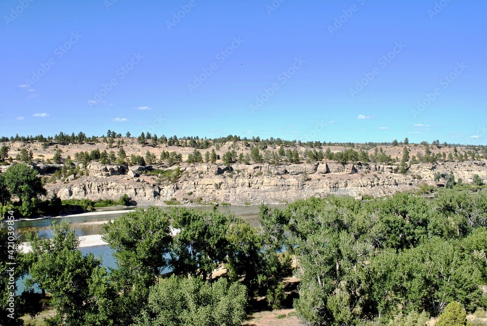 Yellowstone River reflects sandy bluffs. (Selective focus) Pompeys Pillar National Monument is a rock formation in south central Montana, United States with the ties to the Lewis and Clark Expedition.