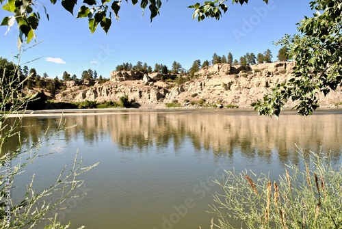 Yellowstone River reflects sandy bluffs. (Selective focus) Pompeys Pillar National Monument is a rock formation in south central Montana, United States with the ties to the Lewis and Clark Expedition. photo