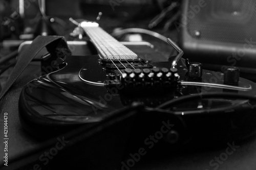 Black electric guitar with tremolo on a hard case