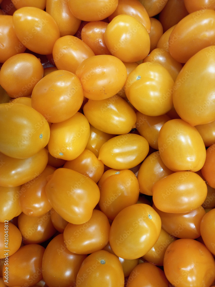 Ripe tomatoes. Yellow plum tomatoes in a box on the Ripe tomatoes. Yellow plum tomatoes in a box on the