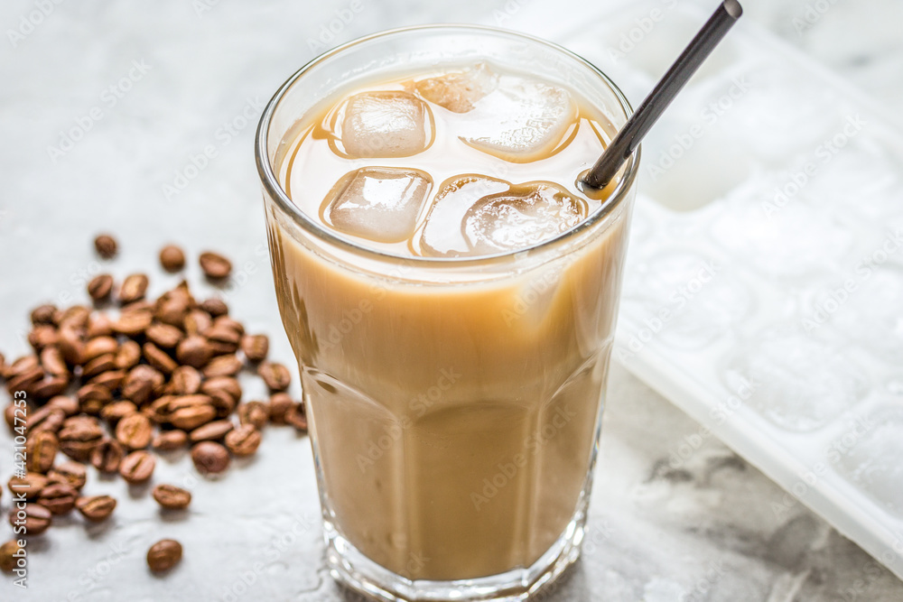 cold coffee glass with ice cubes on stone table background cold coffee glass with ice cubes on stone table background