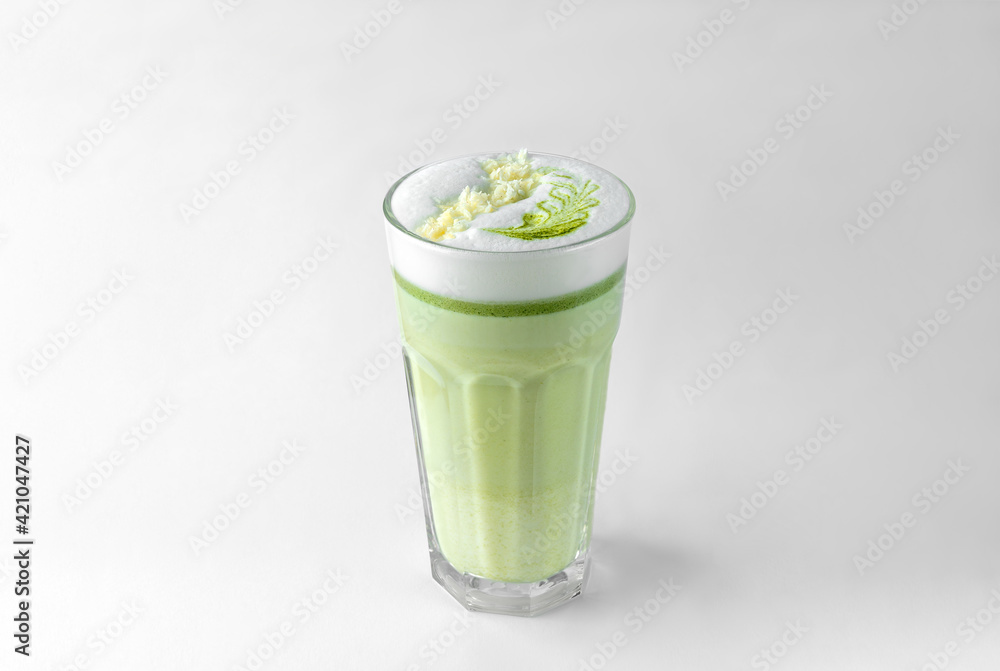 transparent glass with green coffee latte, frothed milk, syrup, whipped cream and topping transparent glass with green coffee latte, frothed milk, syrup, whipped cream and topping