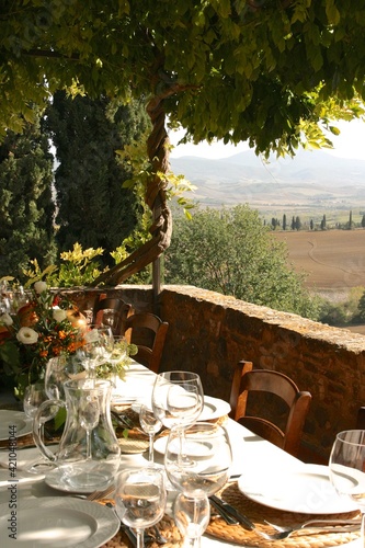 Table set for al fresco dinner on the terrace. Tuscany, Italy 