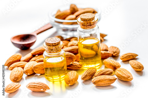 cosmetic set with almond oil on light table background