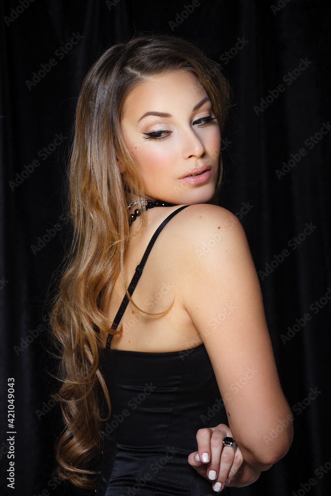 Natural beauty, skincare and haircare. Portrait of beautiful female model with clean face isolated on black background. Young woman shows healthy sensitive skin after using cosmetics and makeup