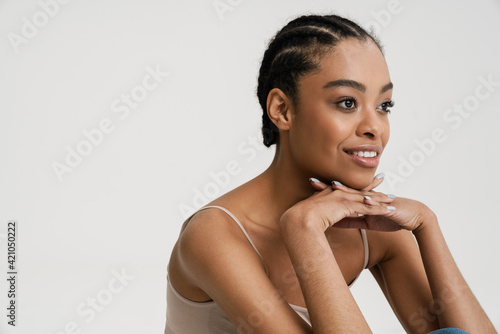 Young african woman wearing brassiere smiling and looking aside