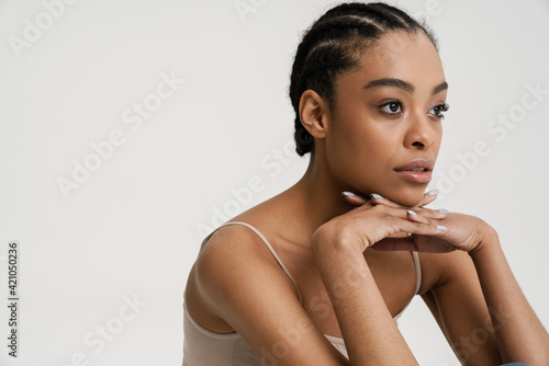 Young african woman wearing brassiere posing and looking aside