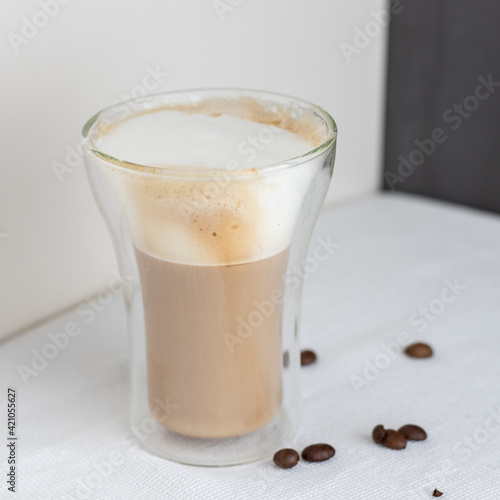A double glass cup of cappuccino 