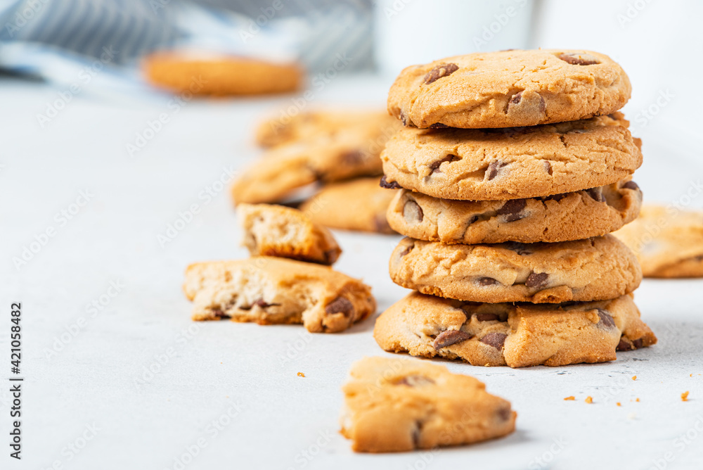 Heap of chocolate chip cookies on a gray table close-up. Sweet breakfast. Stack of traditional chip cookies with chocolate chunks. Heap of chocolate chip cookies on a gray table close-up. Sweet breakfast. Stack of traditional chip cookies with chocolate chunks.