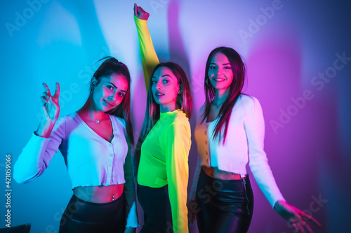 Girlfriends party lifestyle in a nightclub with blue and pink neon lights
