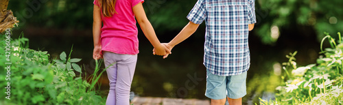 Girl and boy standing together in the park.