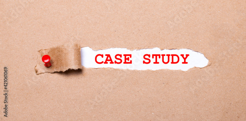 Beneath the torn strip of kraft paper attached with a red button is a white paper labeled CASE STUDY