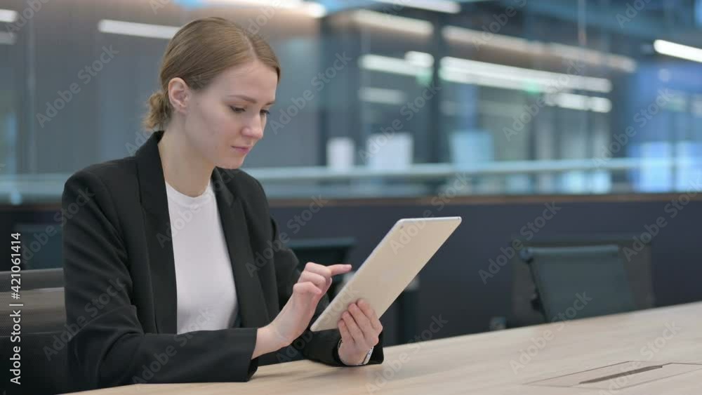 Attractive Businesswoman using Tablet at Work Attractive Businesswoman using Tablet at Work