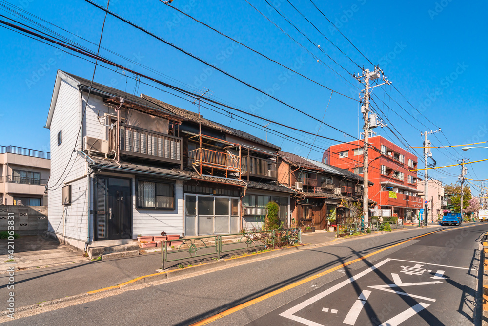 Typical japanese houses from Showa era rehabilitated as Coffee Shop in the downtown rural district of Yanaka and Sendagi with old balconies made in rusty metal.