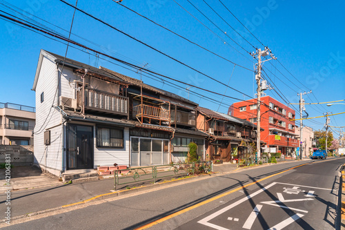 Typical japanese houses from Showa era rehabilitated as Coffee Shop in the downtown rural district of Yanaka and Sendagi with old balconies made in rusty metal. photo