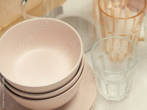 Plastic bowls and water glasses set for kitchen utensils or tableware.