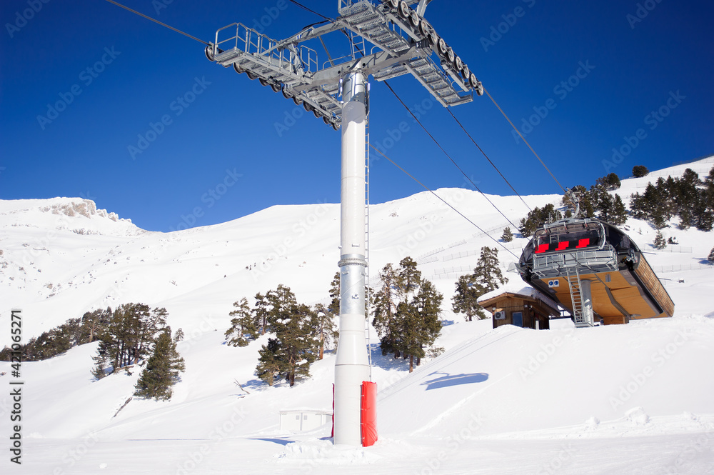 Fototapeta premium Winter mountains panorama with ski slopes and ski lifts.