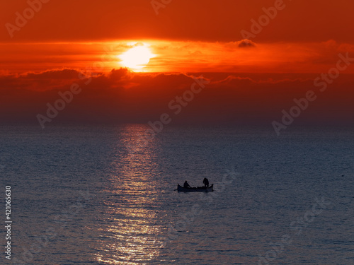 Sunrise and fishing boat silhouette at Black Sea