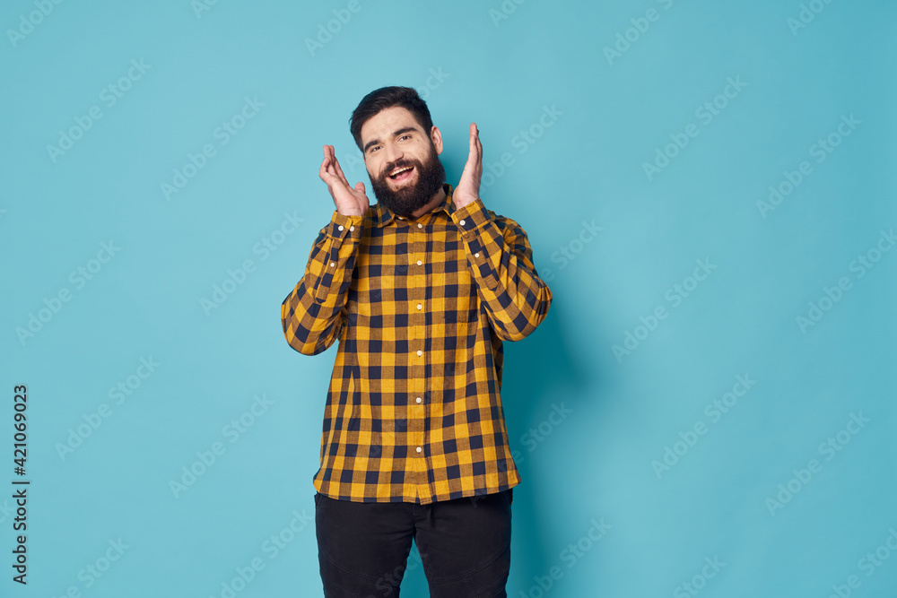 A guy with a bushy beard in a plaid shirt is laughing A guy with a bushy beard in a plaid shirt is laughing