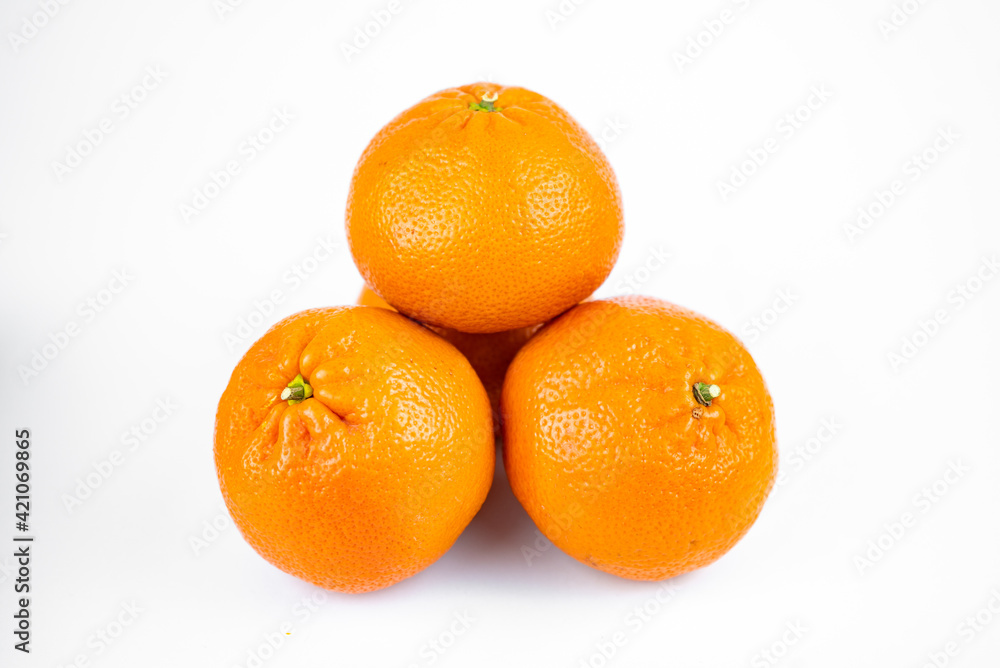 Ripe fresh juicy tangerines with leaves on white background Ripe fresh juicy tangerines with leaves on white background