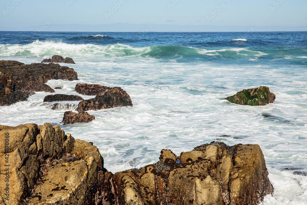 Beautiful seascape of the Pacific coast in California, waves, rocks, sky, sun. Concept, perfect postcard and guide. Beautiful seascape of the Pacific coast in California, waves, rocks, sky, sun. Concept, perfect postcard and guide.