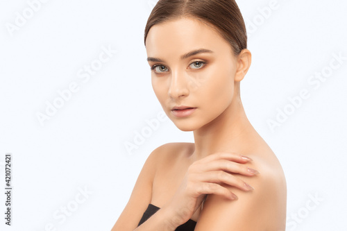 Portrait of a beautiful brunette girl with healthy clean skin and fresh make-up. Aesthetic cosmetology and makeup concept.