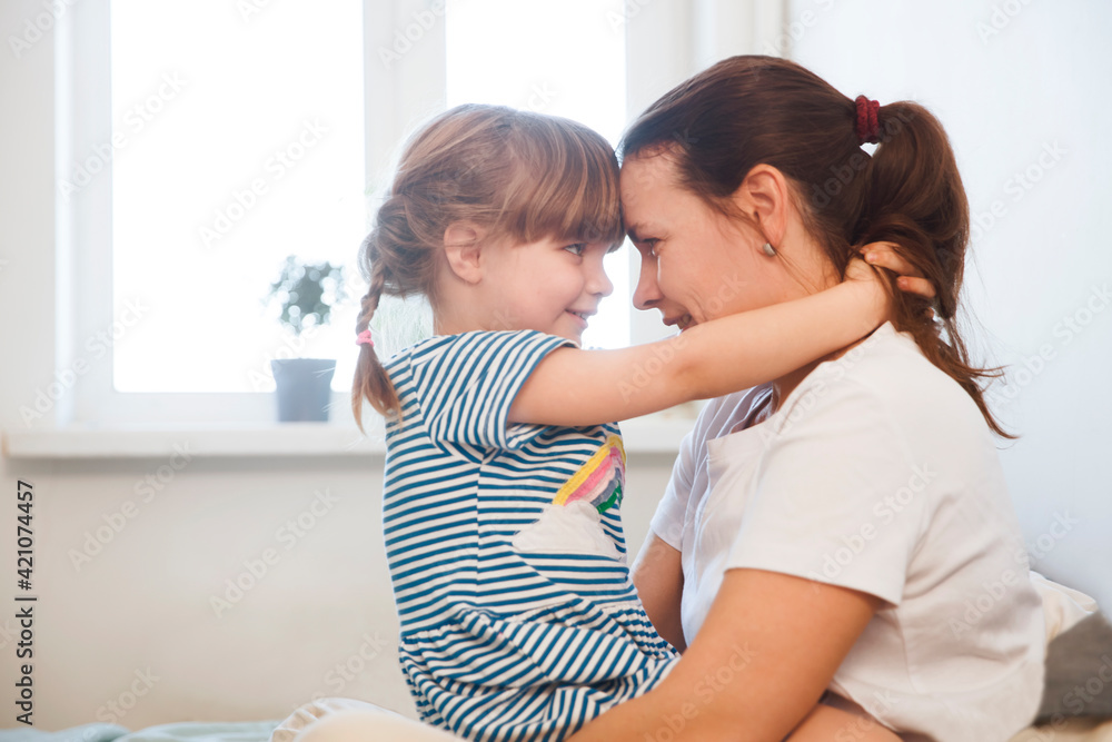 Mother and little girl hugging and. Mother's Day. morning time together Mother and little girl hugging and. Mother's Day. morning time together