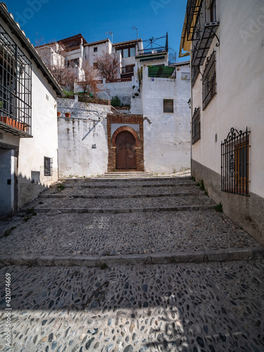 narrow street with stairs in the Albaicin in old city of Granada, Spain © Hans Hansen