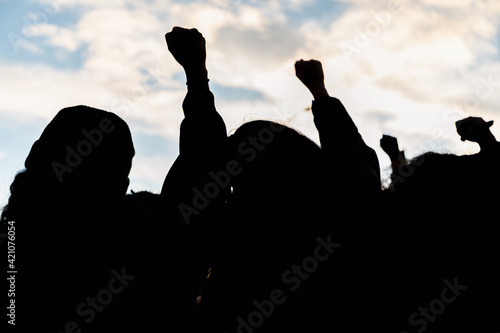 People holding fist up in the air 