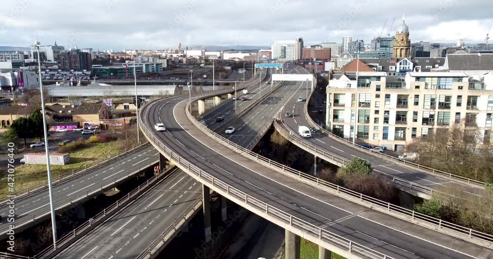 Aerial drone shot reveals spectacular elevated highway and convergence of roads, bridges, viaducts in Glasgow at sunset, transportation and infrastructure development in urban Scotland Aerial drone shot reveals spectacular elevated highway and convergence of roads, bridges, viaducts in Glasgow at sunset, transportation and infrastructure development in urban Scotland