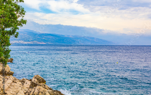 Wonderful turquoise and rocky beach and promenade Novi Vinodolski Croatia. photo