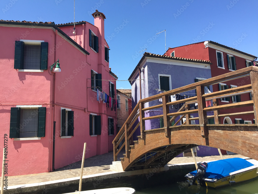Burano canal natural color pink and lavender buildings and  footbridge