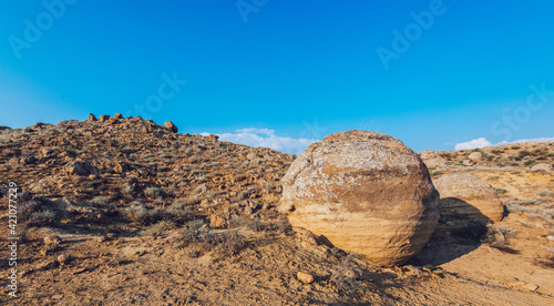 Big round boulder among rocky formations