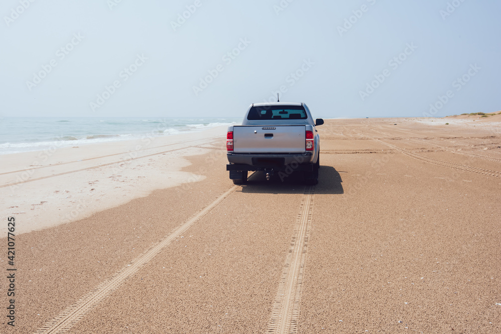 Car on empty beach near sea Car on empty beach near sea