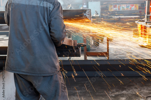 metal processing at the enterprise by an employee with his back to us