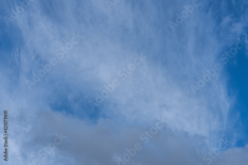 Thin layer of white cirrus clouds on a blue sky