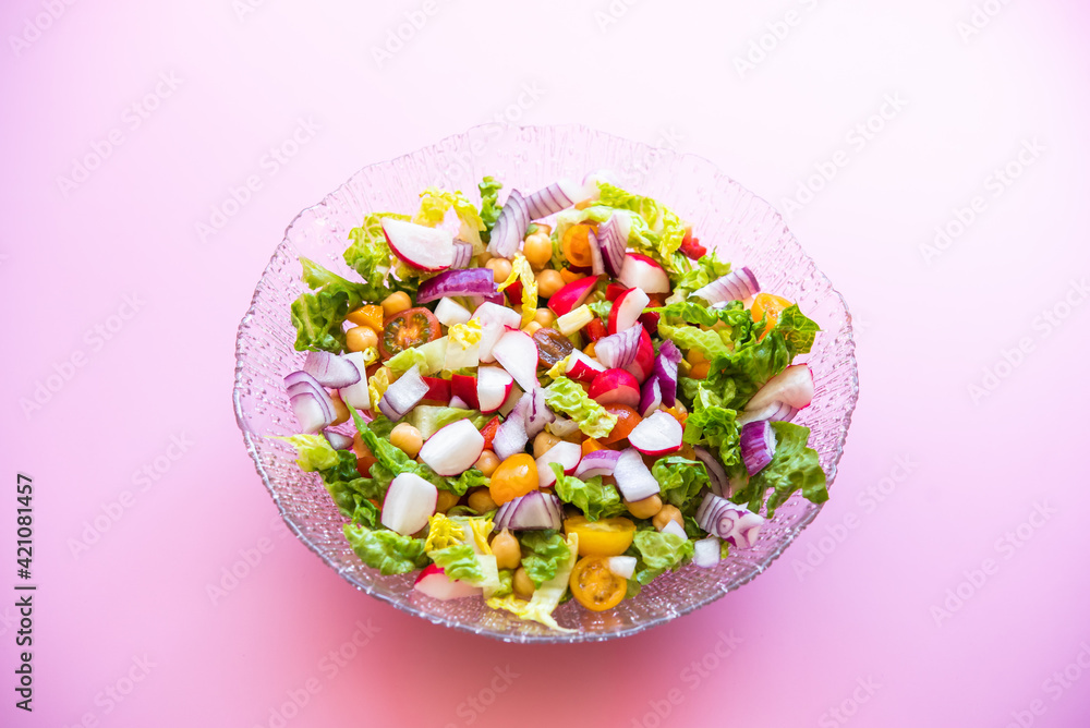 fresh salad on pink background. Mediterranean salad