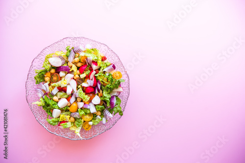 fresh salad on pink background. Mediterranean salad © OMP.stock