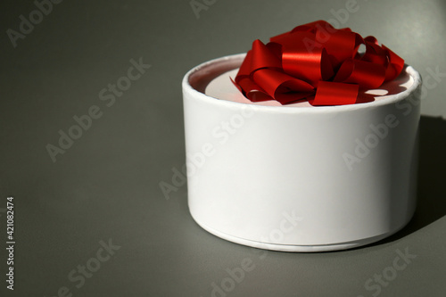 A gift box with a red bow. Holiday concept with free space for text, greeting card