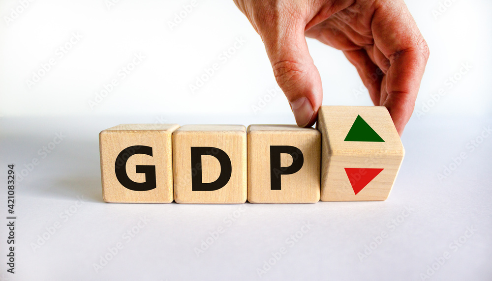 GDP, gross domestic product symbol. Businessman holds a cube with up ...